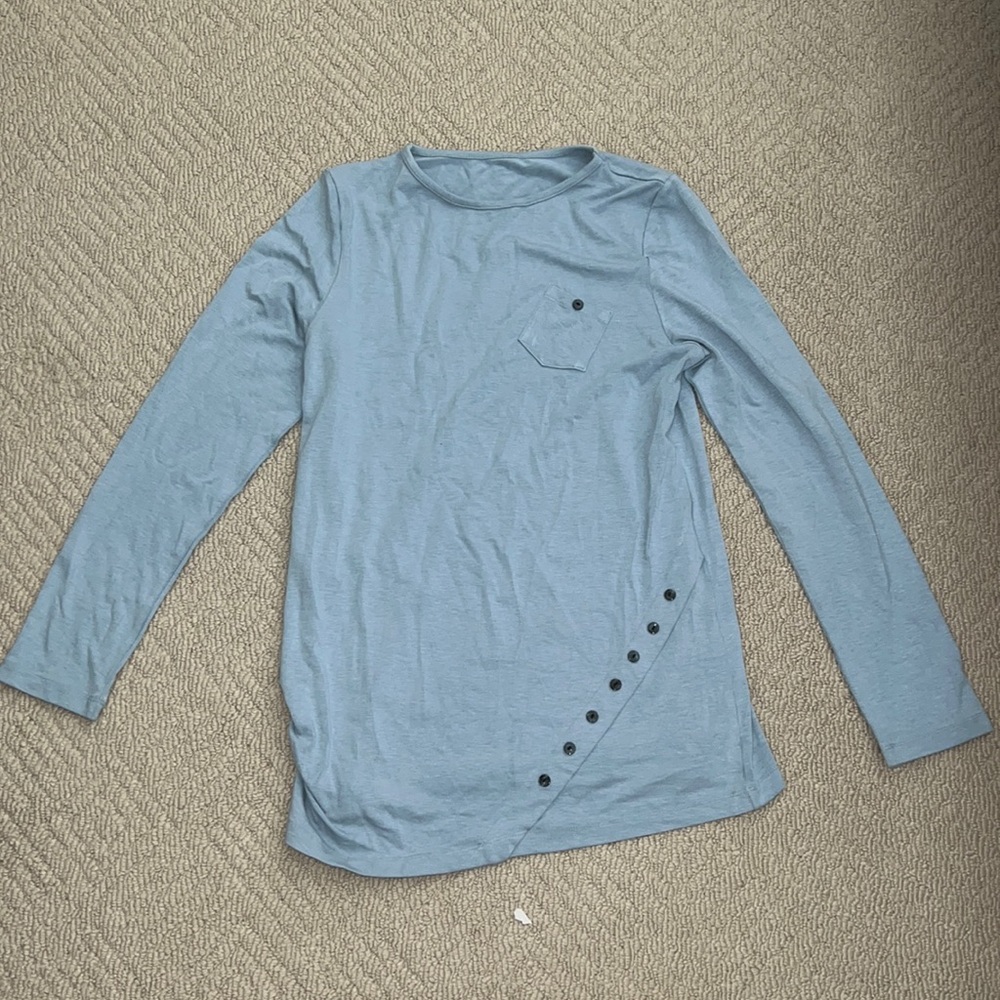 Light blue long-sleeved shirt with decorative buttons